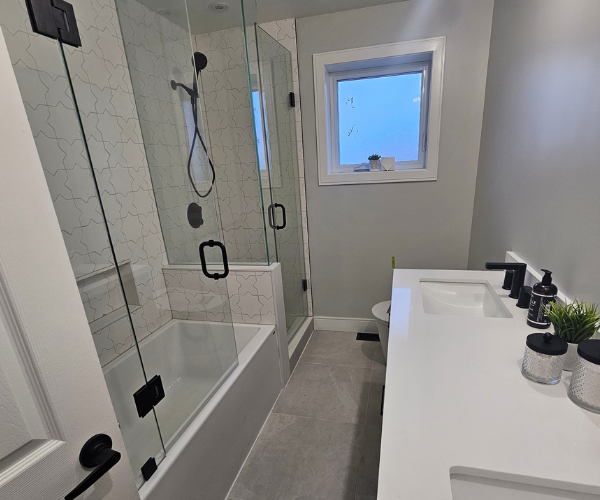 Completed frameless glass walk-in shower and tub enclosure in West Toronto.