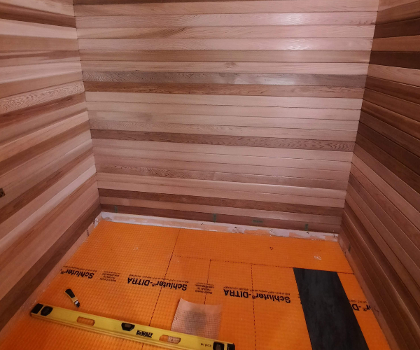 Schluter DITRA HEAT floor warming membrane installation for custom home sauna.